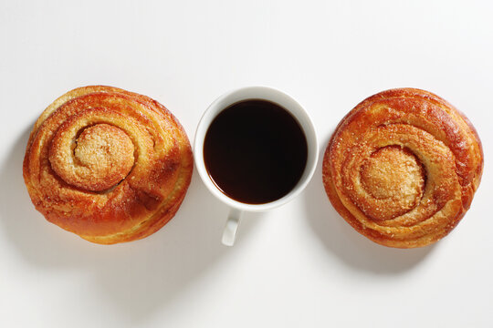 Two Cinnamon Buns and Black Coffee