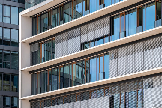 Modern apartment facade architecture with residential windows glass and louver creating geometric pattern for real estate marketing showing exterior detail
