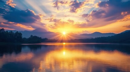 Fototapeta premium Spectacular Sunrise or Sunset Over Majestic Mountains Reflected on a Tranquil Lake with Vibrant Light