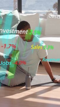 Vertical video: Man settling on mat, tapping phone and updating market charts while tracking funds
