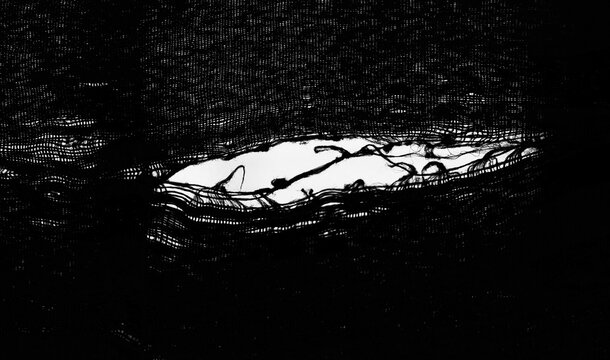 teared rag spread isolated on white background backdrop pattern texture. hole in tissue black fabric torn stitch hole loose threads Torn fabric with frayed edges Mockup mock up mock-up template blank