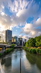 Obraz premium A cityscape with a river and bridge under a cloudy sky