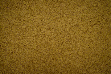 Fototapeta premium Close up view of sandy texture on the beach showing warm tones of golden sand under sunlight in mid-afternoon hours