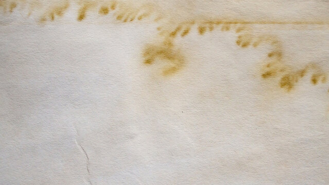 Old vintage paper texture background with aged stains and antique yellowed parchment effect