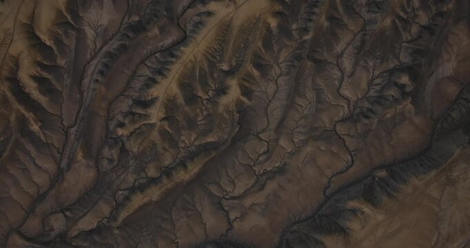 Close aerial of intricate erosion ridges forming abstract desert patterns in Utah, top down textured backdrop