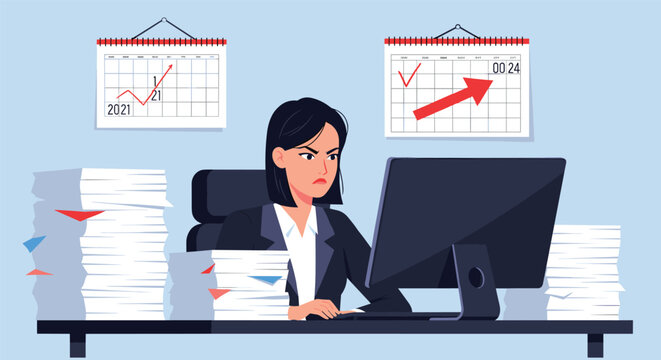 Stressed and angry businesswoman working on her computer surrounded by overwhelming stacks of paperwork and performance growth charts.