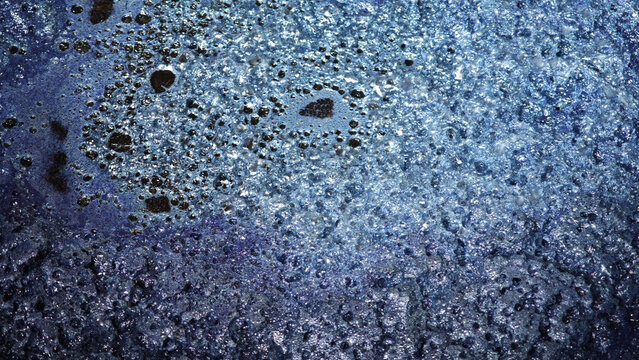 The indigo dye is fermenting in a tank to create fine bubbles, which will settle in the indigo solution used for dyeing.
