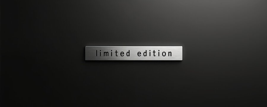 Metal plaque with limited edition text on dark background. This sign denotes scarcity or exclusivity for products or promotions. Minimalist design.