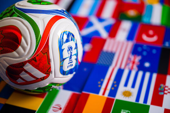 FIFA 2026 Match Ball Featured on Green Turf with Out-of-Focus International Flags Scene