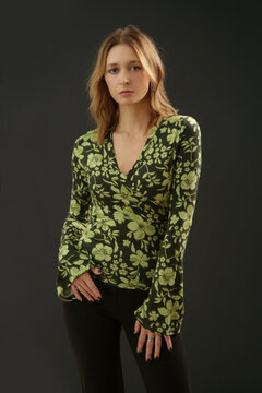Studio Fashion Portrait of Woman in Green Floral 70s V Neck Cotton Shirt with Black Flared Pants