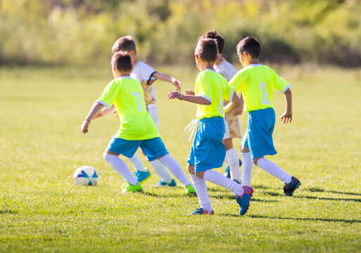 Kids soccer football - children players match on soccer field