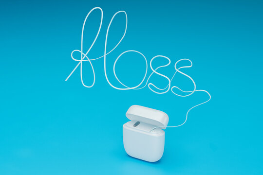 Floss in the shape of the word FLOSS on a blue background. 3d render