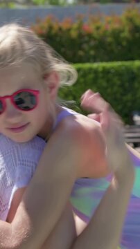 Vertical video: Mother hugging daughter on yard daughter approaching in shades for family reunion