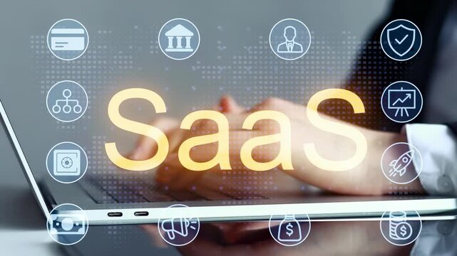 Focus on SaaS and cloud computing while using a laptop in a modern office setting during daytime.