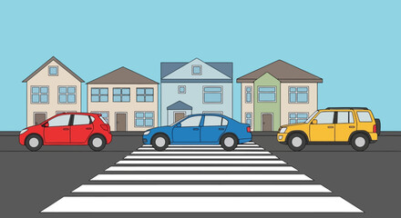 Obraz premium Cars crossing at a pedestrian zebra crossing in front of houses