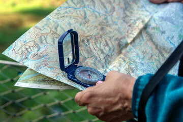 Senior hand holding compass and map navigating outdoor adventure © AlvaroRT