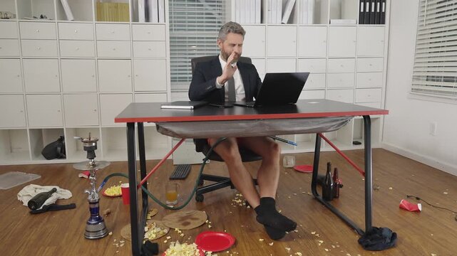 Comic Businessman in messy office. Funny business man during a video conference in messy office. Crazy business concept. Fun business team online. Humor in business. Messy funny office workspace.