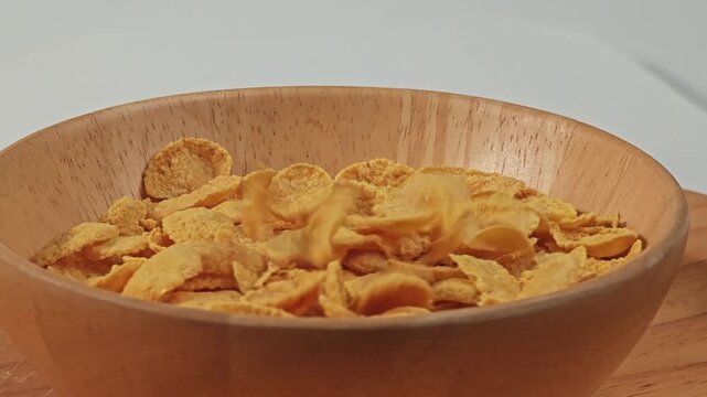 Crispy corn flakes in wooden bowl.