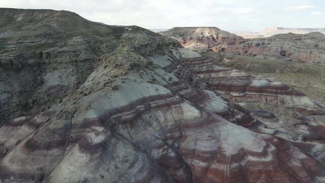 Professional 4K drone footage featuring a forward cinematic flight transitioning into a graceful right turn over the Bentonite Hills near Capitol Reef, Utah. Shot at 60fps for seamless slow-motion.