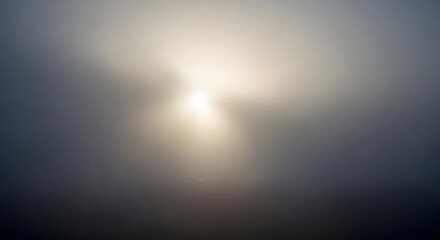 Obraz premium Bright sun rays flash through blue clouds in a nature background texture with a glowing light gradient across the sky