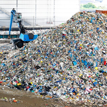 Large pile of mixed recyclable waste at industrial recycling plant