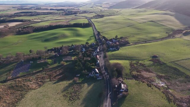 Traditional Scottish village of Silverburn nestled at the foot of the majestic Pentland Hills surrounded by green fields and rural roads