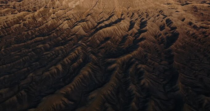 Eroded desert ridges and gullies forming patterned badlands near Factory Butte Utah, drone