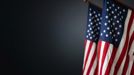 Obraz premium Two American flags with stars and stripes are displayed vertically against a dark background offering ample copy space