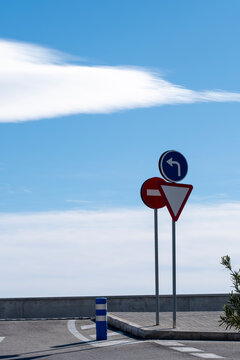 Traffic sign in urban street intersection gives direction for turn and priority on roadway supporting safety and mobility navigation