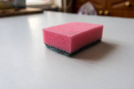 Pink kitchen sponge on countertop