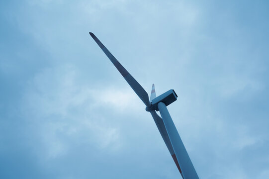 Turbine Blade Low Angle Dramatic Sky, Close Perspective Emphasizes Scale And Sleek Metal Surface Against Deep