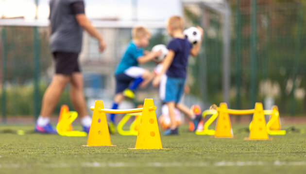 Soccer Football Training Session for Kids. Boys Training Football on the Pitch. Soccer Stadium in the Background. Young Soccer Boys Improving Strength and Agility Skills Outdoor