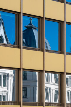 Oslo urban cityscape highlights glass windows reflection pattern with modern architecture contrast using geometric facade grids and minimalist design
