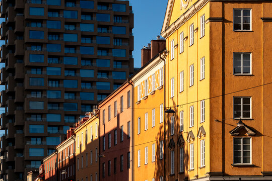 Stockholm urban cityscape pairs tenement facade windows with modern highrise architecture contrast showing layered streetscape and housing density