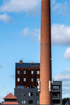 Stockholm urban cityscape shows smokestack industrial architecture contrast with modern apartment skyline highlighting regeneration and housing development