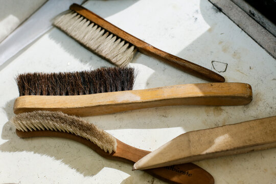 Brushes and cleaning tools on workshop surface