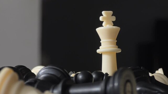 White King Standing Alone Among Fallen Chess Pieces - Resilience Concept