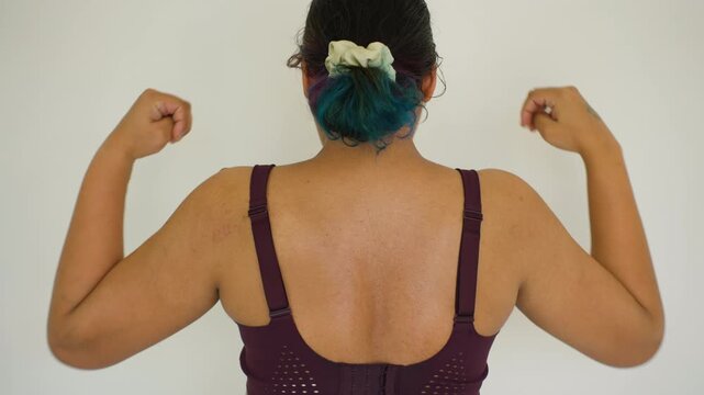 Third trimester young Indian female doing yoga shoulder stretching for flexibility and strength