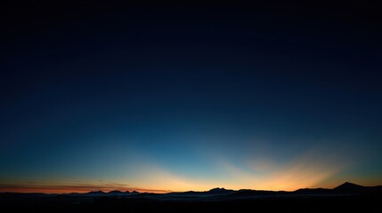 Fototapeta premium predawn. Golden rays of dawn breaking over the horizon into a deep blue pre-dawn sky. travel magazines, destination branding, designed for outdoor magazines and nature guides, used by ux designers.