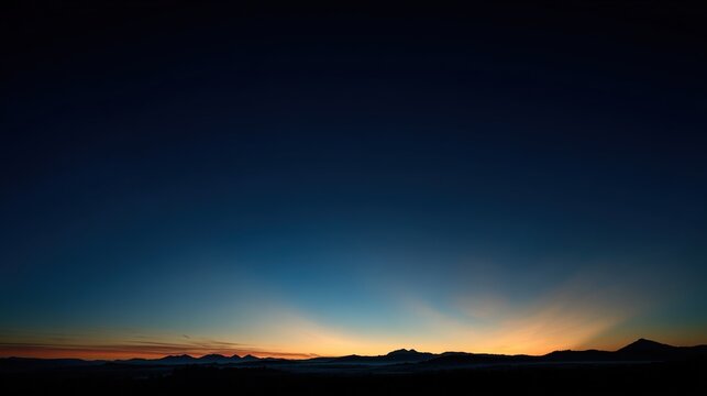 predawn. Golden rays of dawn breaking over the horizon into a deep blue pre-dawn sky. travel magazines, destination branding, designed for outdoor magazines and nature guides, used by ux designers.