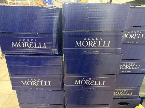 Mallorca, spain, april 20, 2026, acqua morelli mineral water boxes stacked on pallets in warehouseretail storage, ready for sale, shipment and distribution