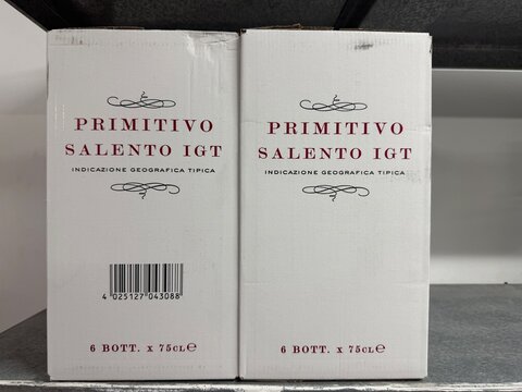 Mallorca, spain, april 20, 2026, primitivo salento igt wine cases on a shelf, featuring brand name, barcode, and bottle count for distribution