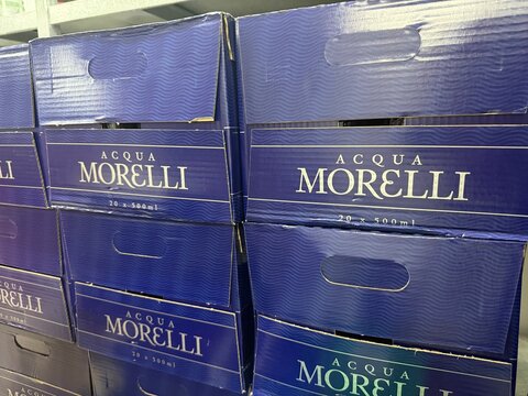 Mallorca, spain, april 20, 2026, acqua morelli mineral water cardboard boxes stacked for retail and distribution in a warehouse or store aisle