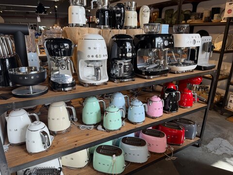 Mallorca, spain, april 20, 2026, smeg brand retro kitchen appliances at retail store, displaying varied colors of espresso machines, kettles, toasters for sale