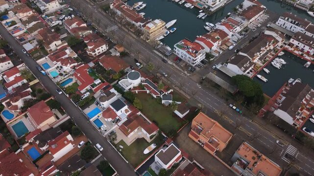 Empuriabrava Costa Brava Spain forward low drone footage over the largest residential marina in Europe showing incredible canalside houses and boats berthed in marinas in this unique town