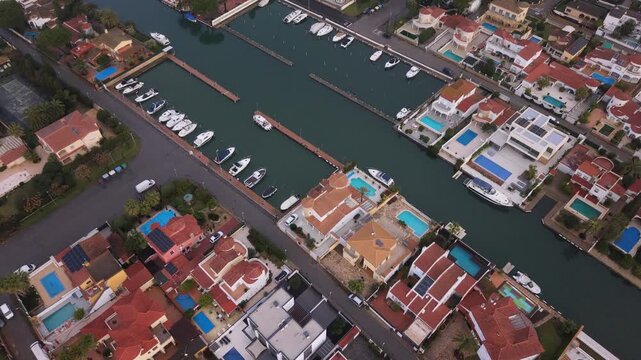 Empuriabrava Costa Brava Spain forward low drone footage over the canals ,marina and town the largest residential marina in Europe showing houses and boats berthed in this unique town