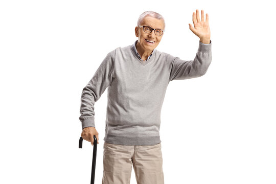 Happy elderly man with a walking cane waving at camera