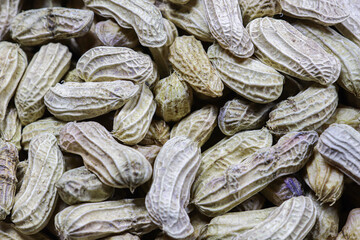 Fototapeta premium Top view boiled peanuts in shell, natural texture background, plant based snack concept with rustic look, healthy street food and organic lifestyle imagery.