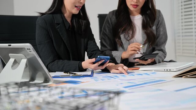 Businessman and team analyzing financial statement Finance task. with smart phone and laptop and tablet. Wealth management concept