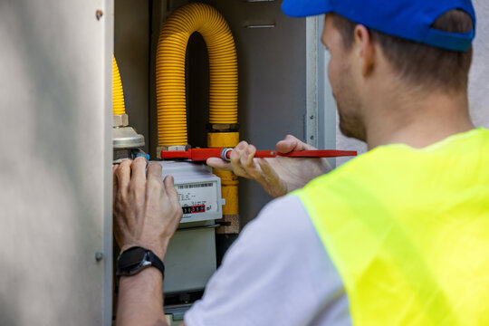 Technician working on natural gas meter. Gas system maintenance and repair service